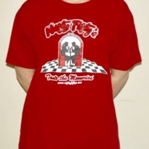 Person wearing a red T-shirt with a graphic of two people dancing in front of a jukebox on a checkered floor, and stylized text that reads “Make Magic” and “Twist the Memories.”.